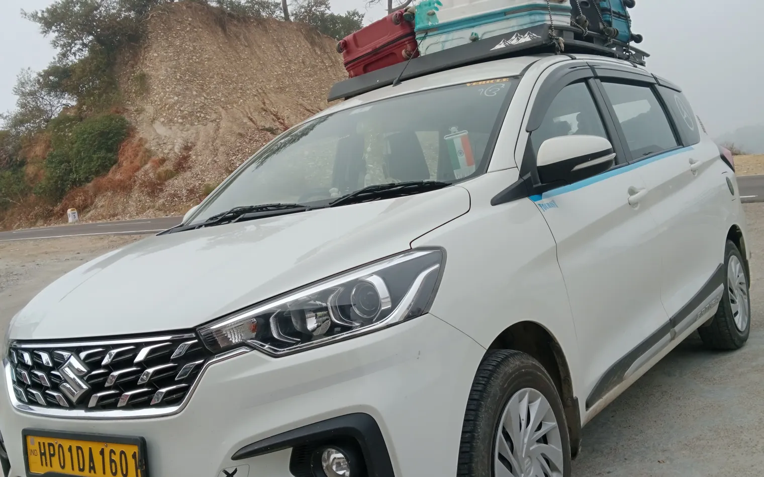 Maruti Ertiga (HP 01 DA 1601) from Baglamukhi Travels, used for corporate staff transport around Kangra