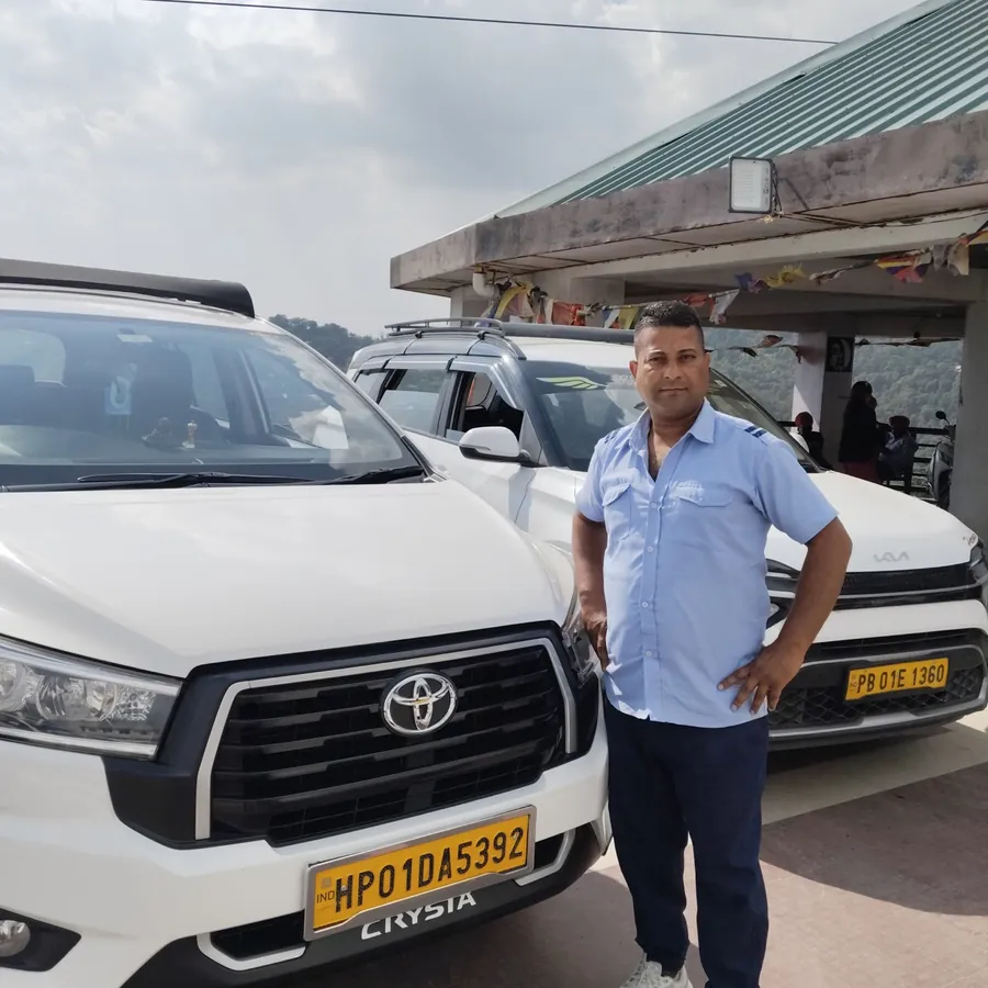 Kapil Dev, owner and driver of Baglamukhi Travels, beside his Toyota Innova Crysta