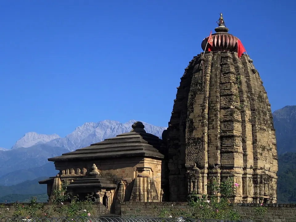 The stone spire of the Baijnath temple, with the Dhauladhar range behind it
