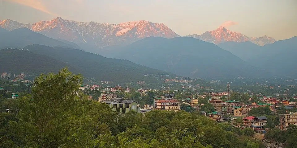 Dharamshala town below the Dhauladhar, the peaks lit pink