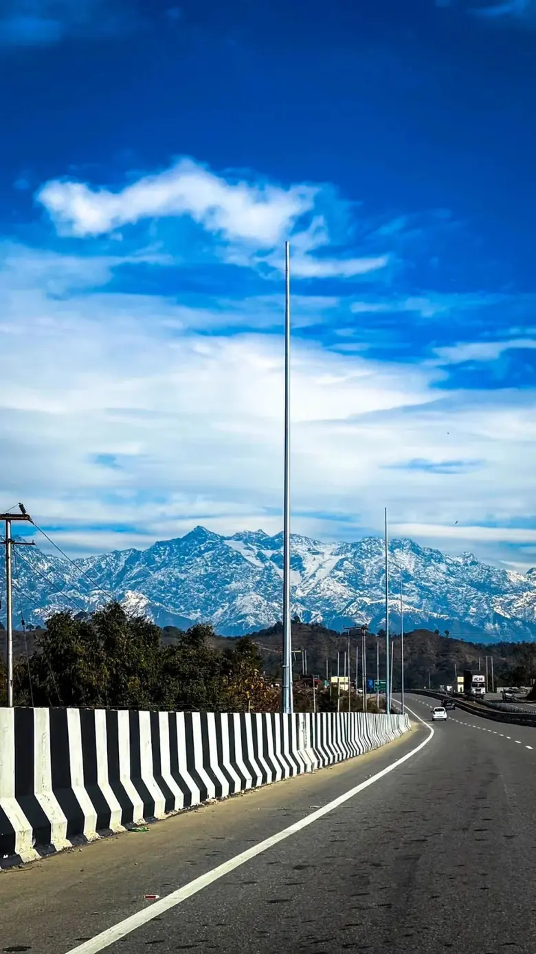 The snow-capped Dhauladhar range over the Kangra valley — the classic Himachal tour landscape